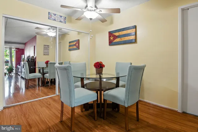 a dining room with furniture a chandelier and wooden floor