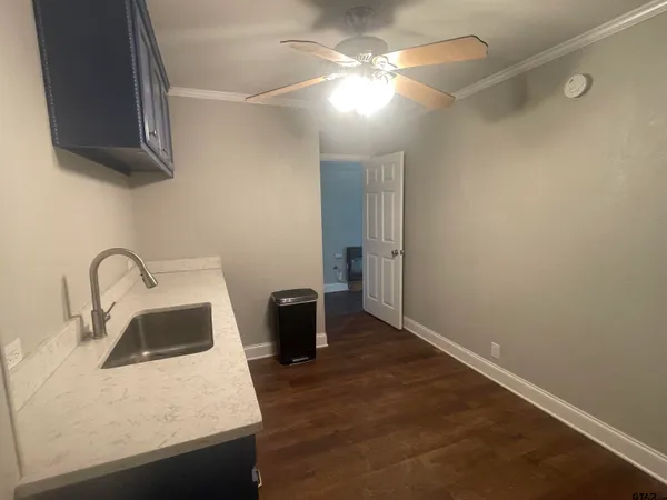 a kitchen with a sink and a refrigerator