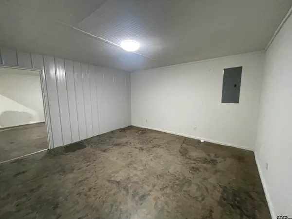 an empty room with a empty space and windows