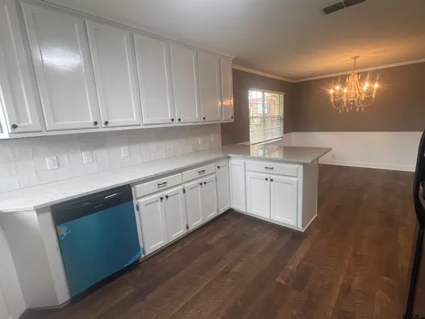 a kitchen with granite countertop white cabinets and white appliances