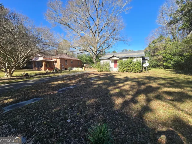 a view of road with large trees