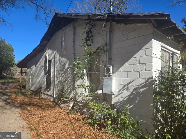 a view of a backyard with wooden fence