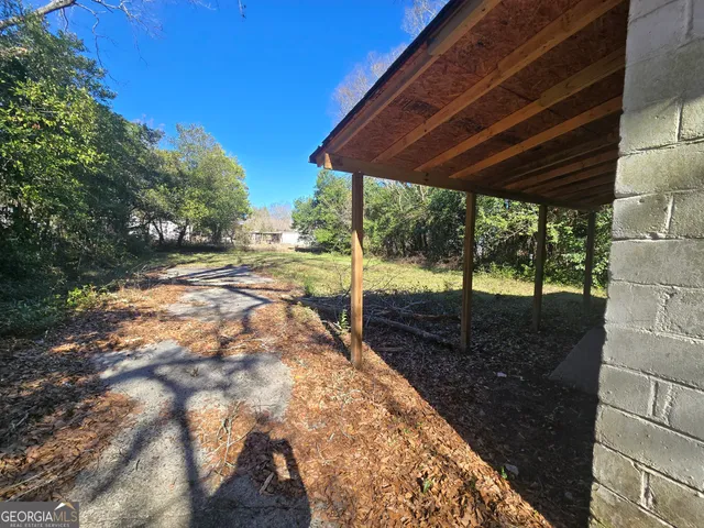 a view of a backyard with wooden floor and roof