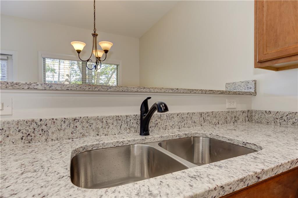 605 Summit Point Canton, GA 30114 - Photo 22 of 56 a kitchen with a sink a counter space and cabinets