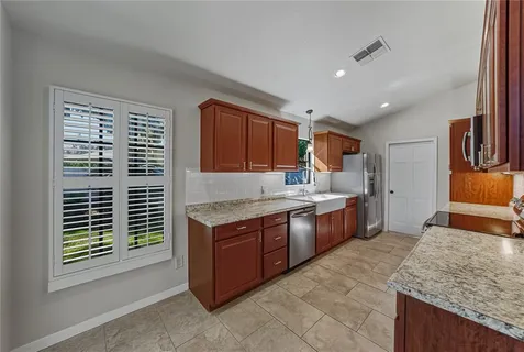 a view of an empty room with a window and fireplace