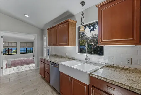 a spacious bathroom with a granite countertop sink and a mirror