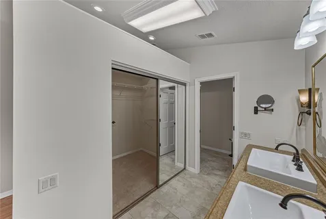 a view of backyard with table and chairs plants and large trees