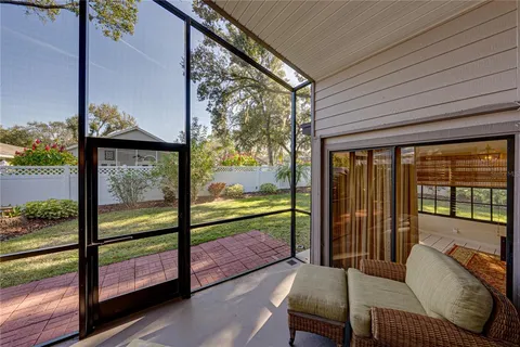 a view of a house with a yard and large tree