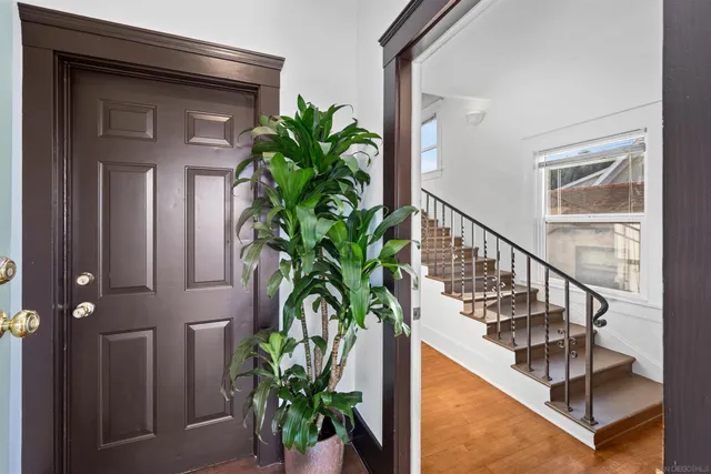a view of staircase with wooden floor and a potted plant