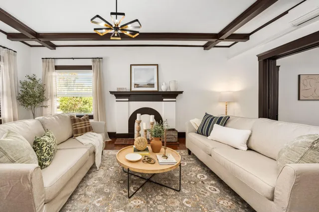 a living room with furniture a rug and a chandelier