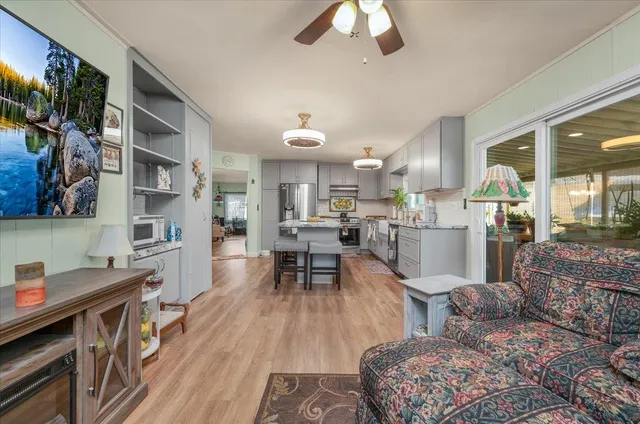 a kitchen with stainless steel appliances granite countertop a refrigerator a stove and a sink