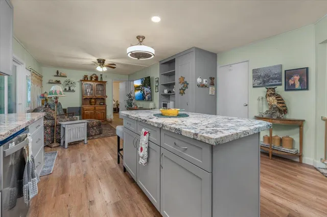 a bedroom with a bed and dresser with mirror