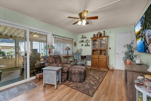 a bedroom with furniture and a fan