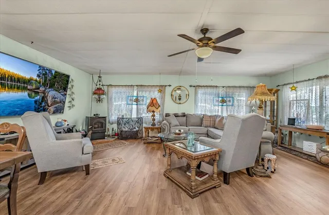 a living room with furniture a ceiling fan and a rug