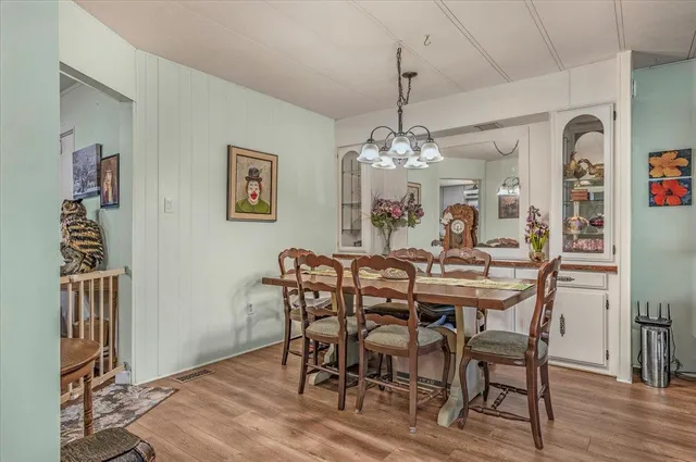 a kitchen with stainless steel appliances granite countertop a sink a stove and a wooden floors