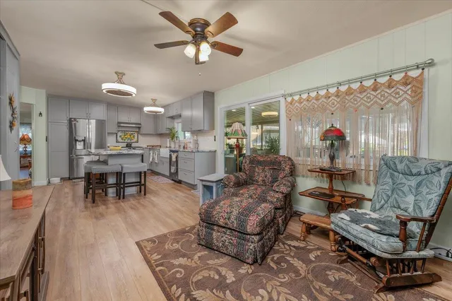 a kitchen with stainless steel appliances granite countertop a sink a stove and cabinets