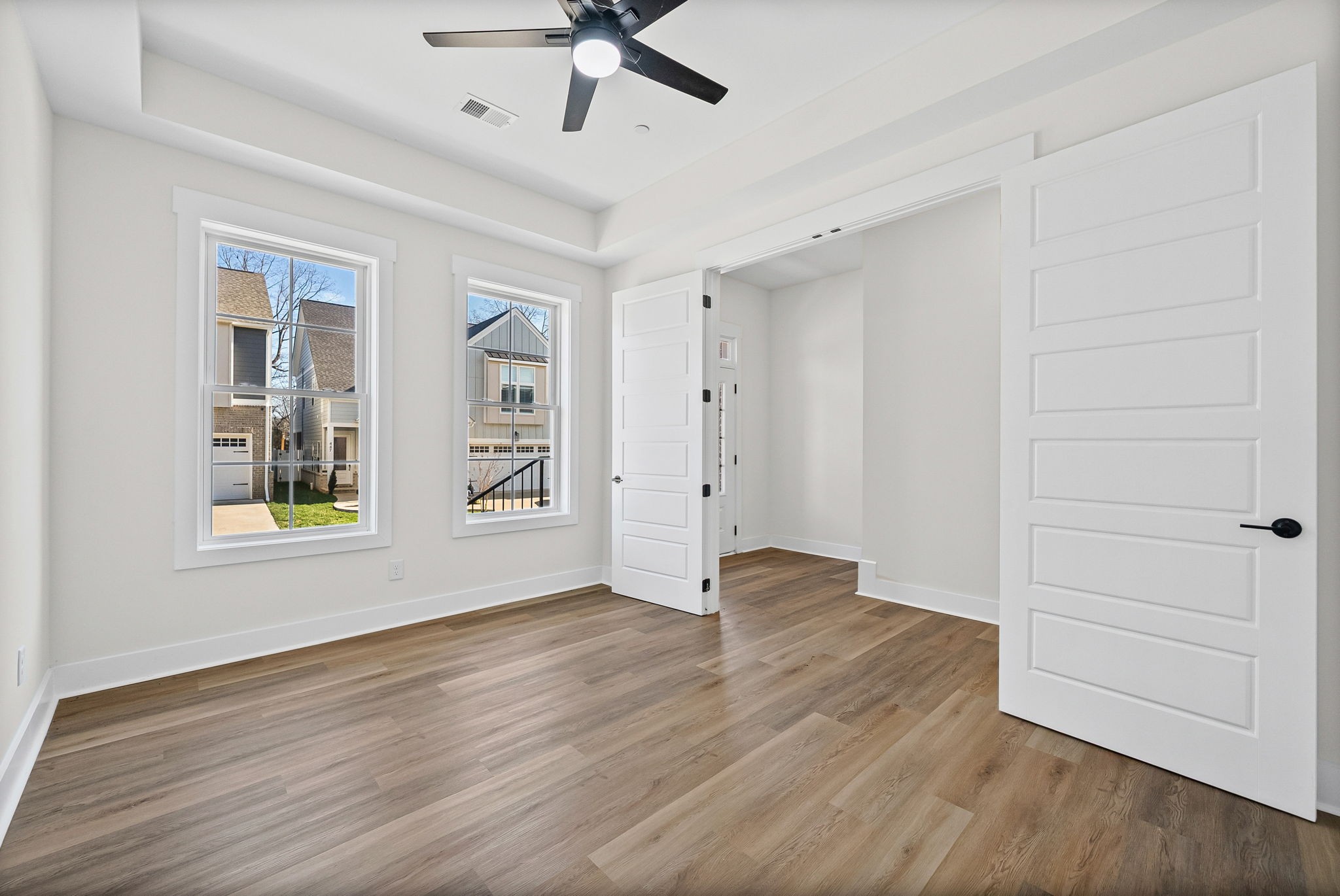442 Centre Street Pleasant View, TN 37146 - Photo 13 of 47 an empty room with wooden floor chandelier fan and windows