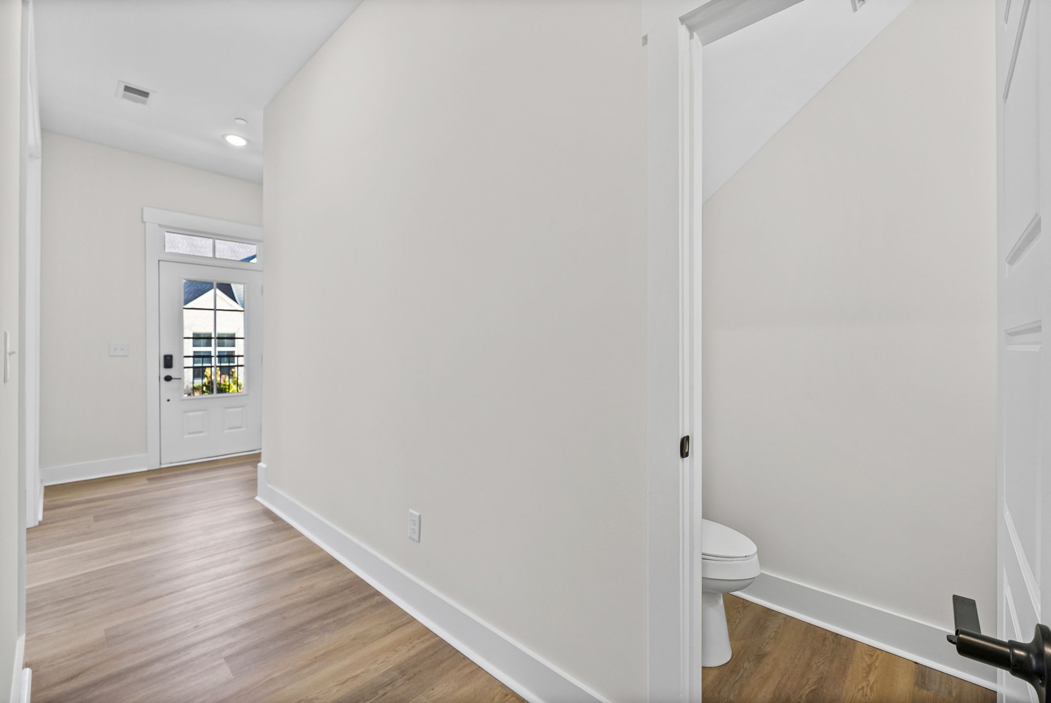 442 Centre Street Pleasant View, TN 37146 - Photo 14 of 47 a view of an empty room with wooden floor and a window