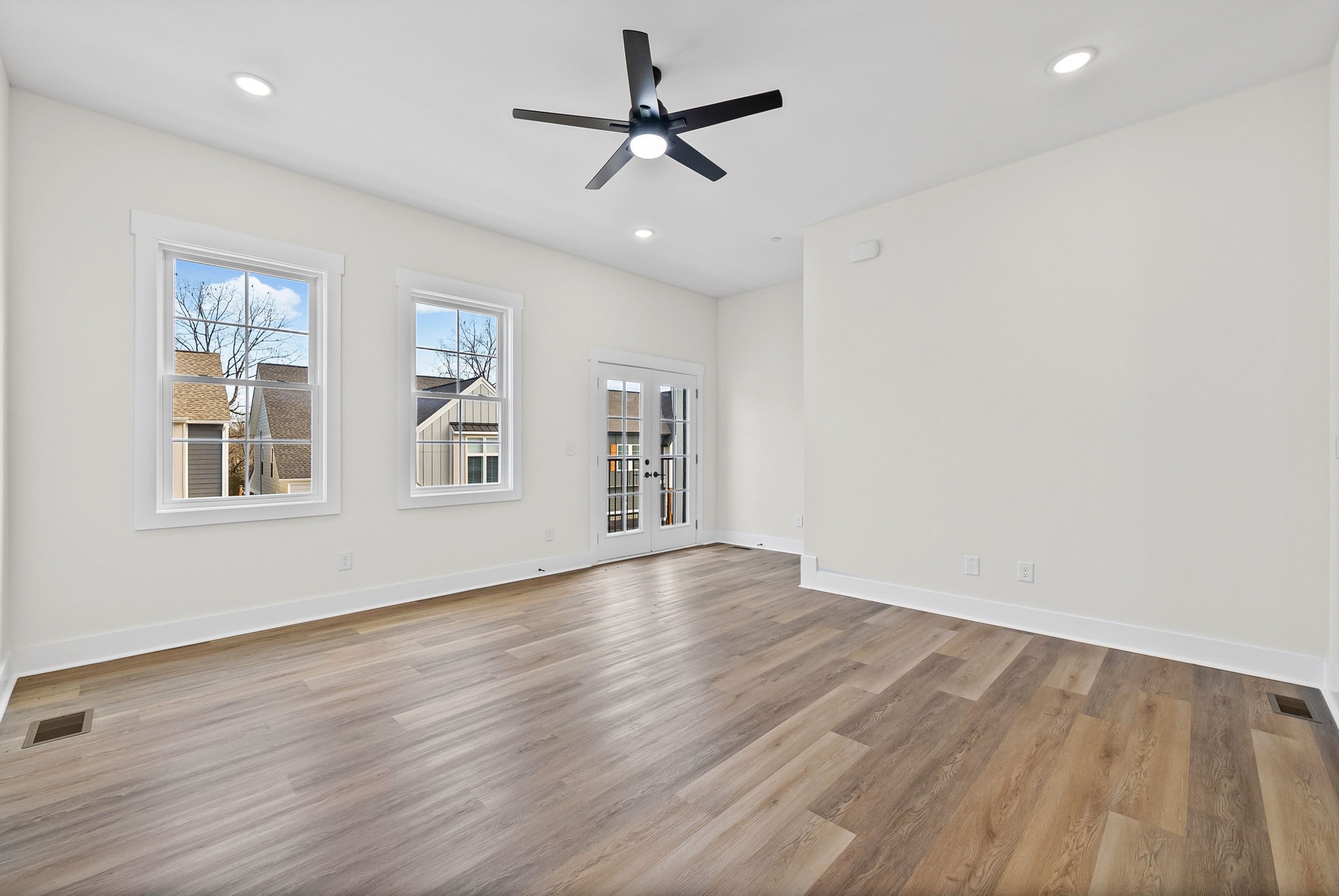 442 Centre Street Pleasant View, TN 37146 - Photo 24 of 47 an empty room with wooden floor chandelier fan and windows