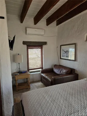 a bedroom with bed and a window