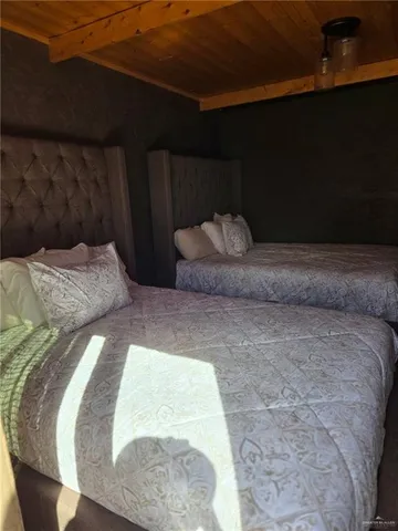 a bed sitting in a bedroom next to a lamp