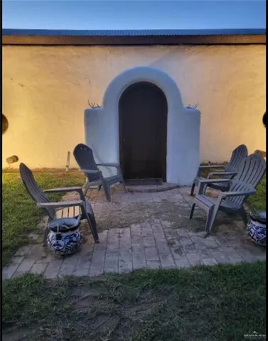 a view of a backyard with plants and outdoor seating