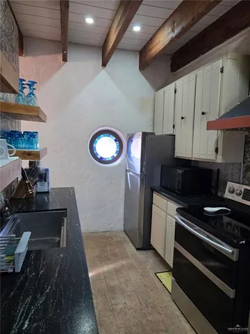a kitchen with a stove and a refrigerator