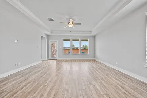 wooden floor in an empty room with a window
