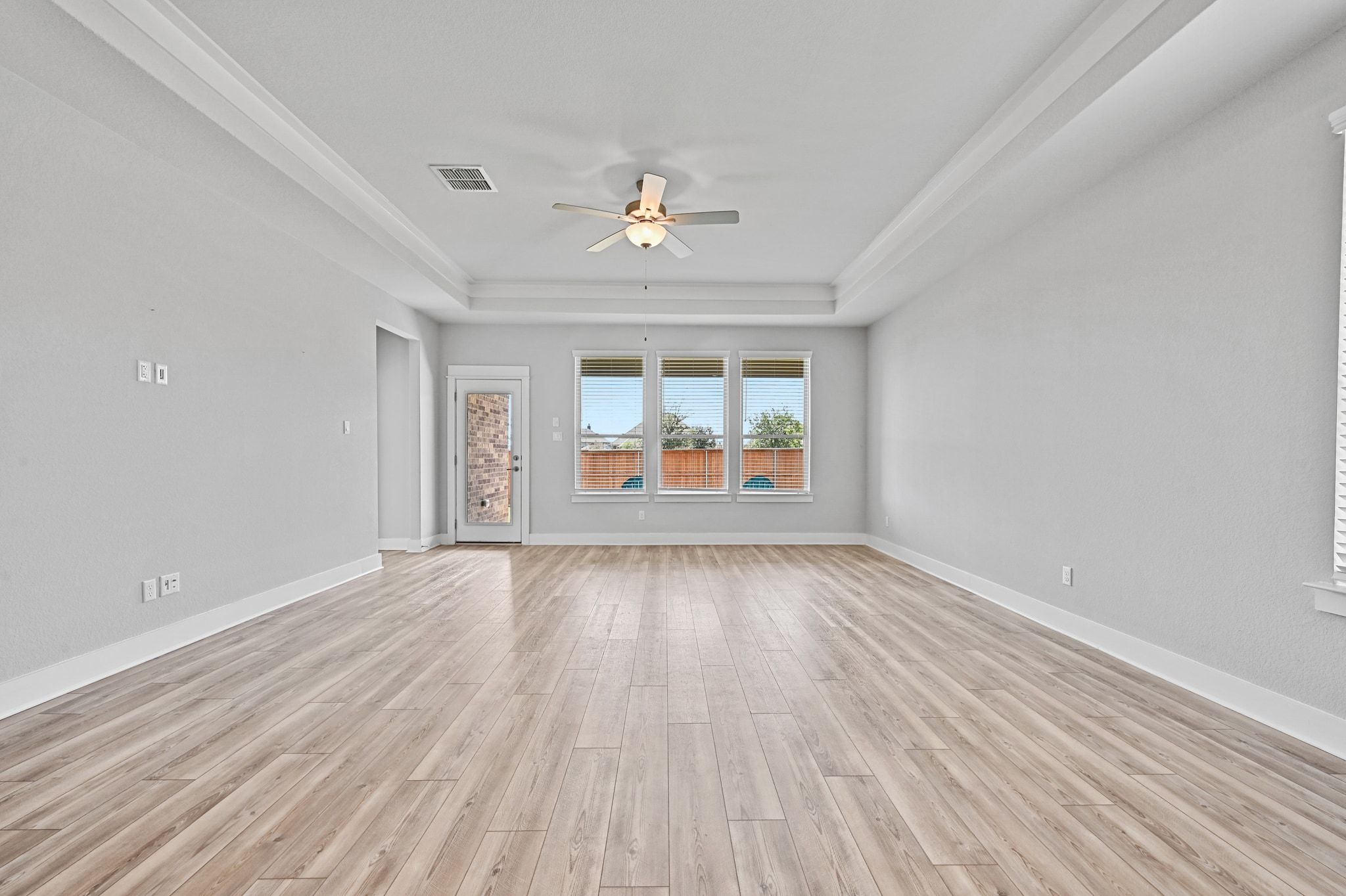 284 Grace Lilly Drive Buda, TX 78610 - Photo 15 of 40 wooden floor in an empty room with a window