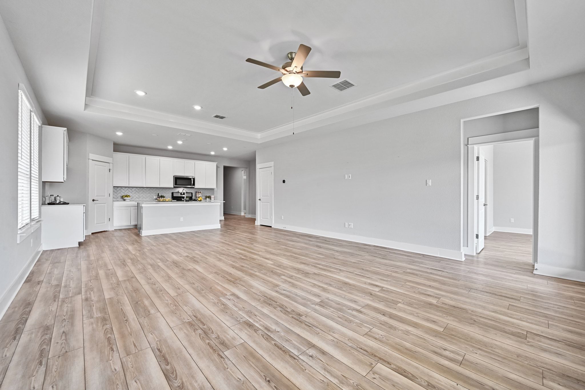 284 Grace Lilly Drive Buda, TX 78610 - Photo 16 of 40 a view of a room with kitchen island stainless steel appliances wooden floor and living room view
