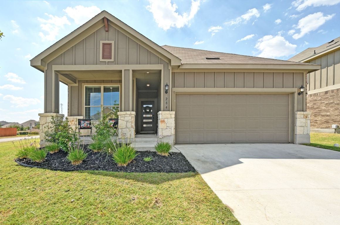 284 Grace Lilly Drive Buda, TX 78610 - Photo 2 of 40 Craftsman inspired home featuring board and batten siding, covered porch, driveway, and a garage