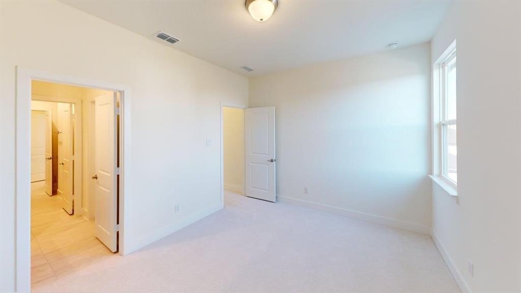 7013 Lathrop Lane Frisco, TX 75033 - Photo 11 of 26 Unfurnished bedroom with light colored carpet and baseboards