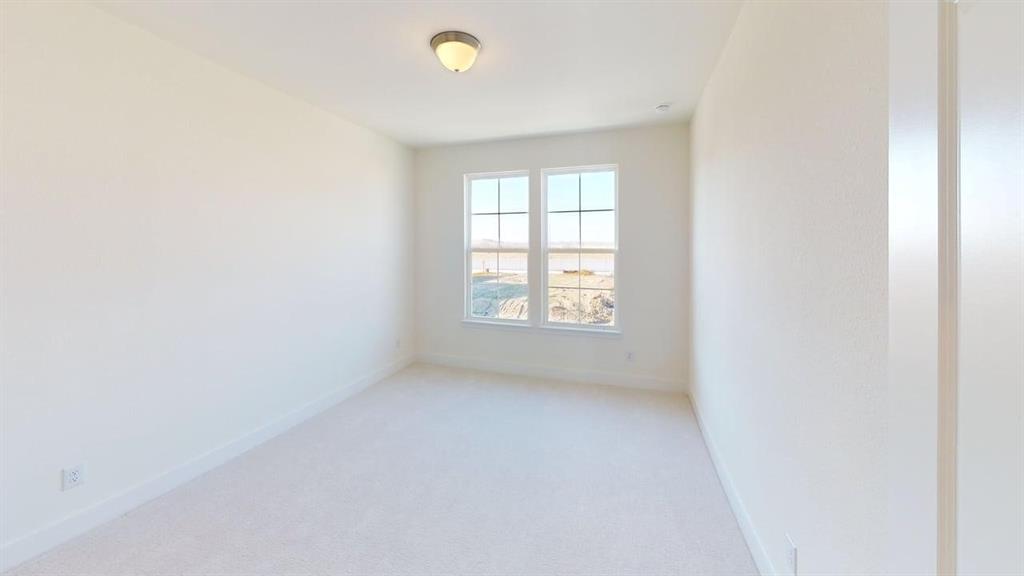 7013 Lathrop Lane Frisco, TX 75033 - Photo 14 of 26 Empty room with light carpet and baseboards