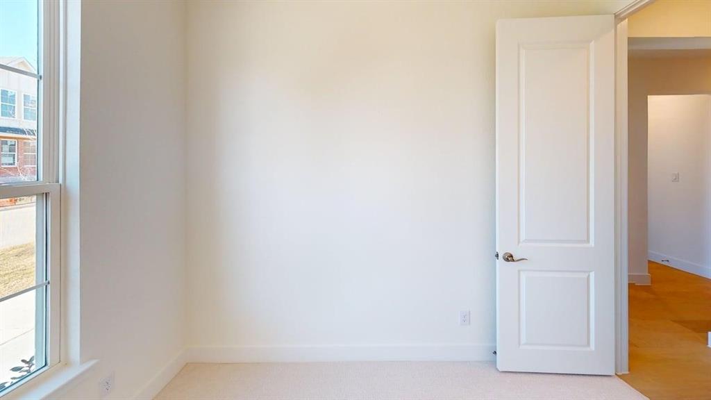 7013 Lathrop Lane Frisco, TX 75033 - Photo 16 of 26 Spare room featuring baseboards and light colored carpet