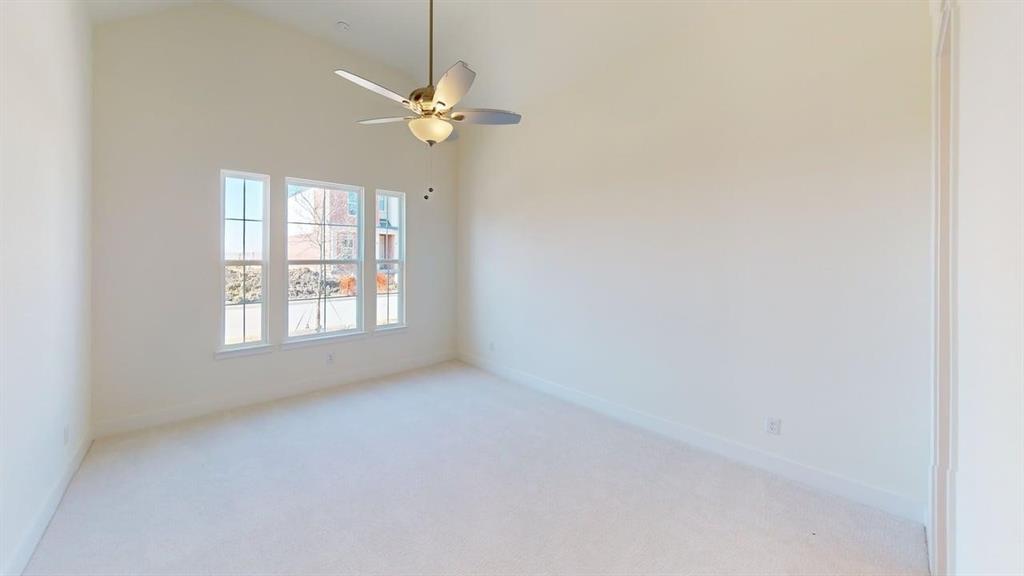 7013 Lathrop Lane Frisco, TX 75033 - Photo 17 of 26 Unfurnished room with light colored carpet, a ceiling fan, and vaulted ceiling
