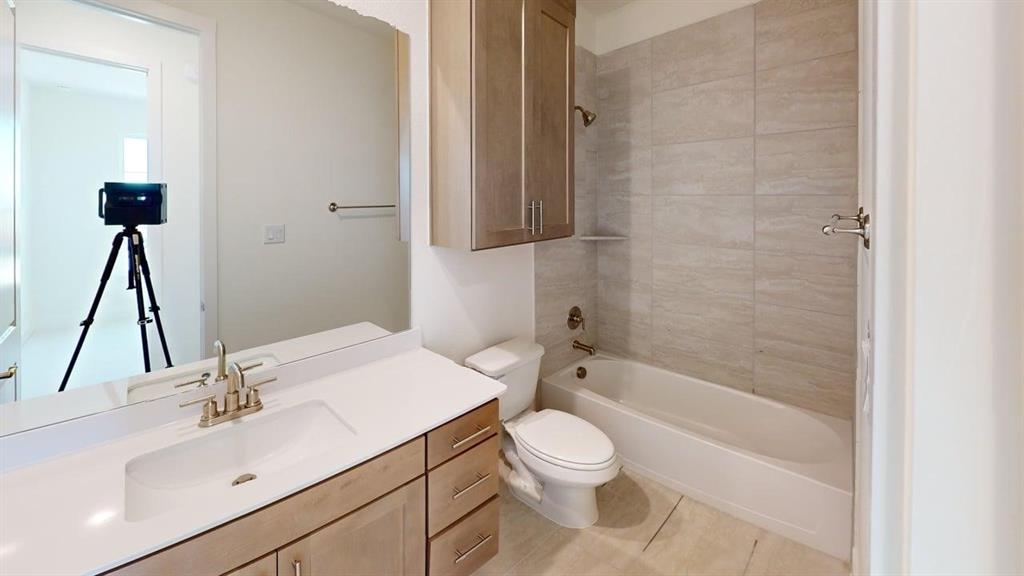 7013 Lathrop Lane Frisco, TX 75033 - Photo 21 of 26 Full bathroom with vanity, shower combination, and light tile patterned flooring