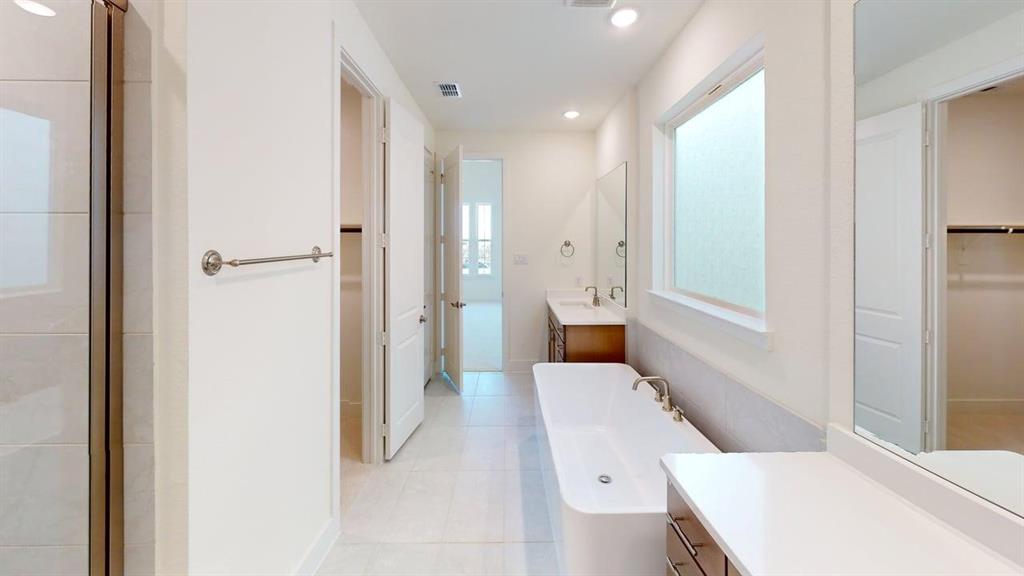 7013 Lathrop Lane Frisco, TX 75033 - Photo 22 of 26 Full bath with a spacious closet, a soaking tub, vanity, recessed lighting, and light tile patterned floors