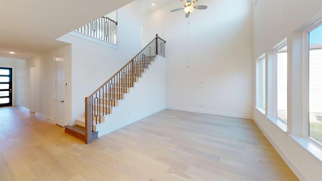7013 Lathrop Lane Frisco, TX 75033 - Photo 6 of 26 Staircase featuring a ceiling fan, wood finished floors, recessed lighting, and a high ceiling