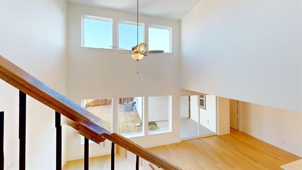 7013 Lathrop Lane Frisco, TX 75033 - Photo 7 of 26 Stairway with plenty of natural light, wood finished floors, and ceiling fan