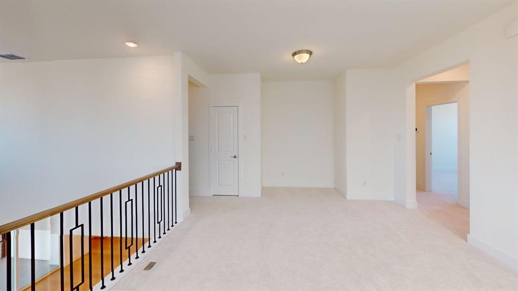 7013 Lathrop Lane Frisco, TX 75033 - Photo 8 of 26 Spare room with light colored carpet and baseboards