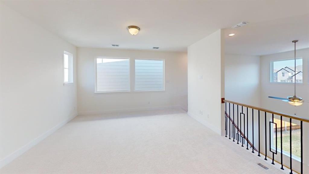 7013 Lathrop Lane Frisco, TX 75033 - Photo 9 of 26 Unfurnished room featuring healthy amount of natural light, light carpet, ceiling fan, and recessed lighting