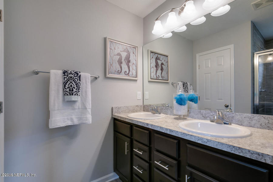 2253 Bayview Road Jacksonville, FL 32210 - Photo 2 of 15 a bathroom with a granite countertop sink a mirror and vanity
