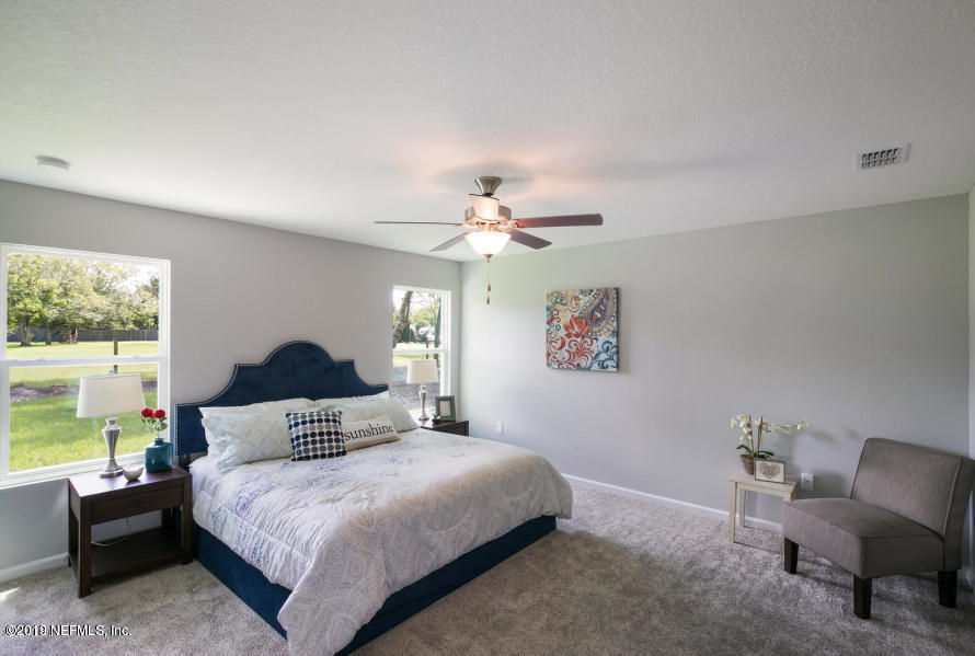 2253 Bayview Road Jacksonville, FL 32210 - Photo 3 of 15 a bedroom with a bed and a chandelier
