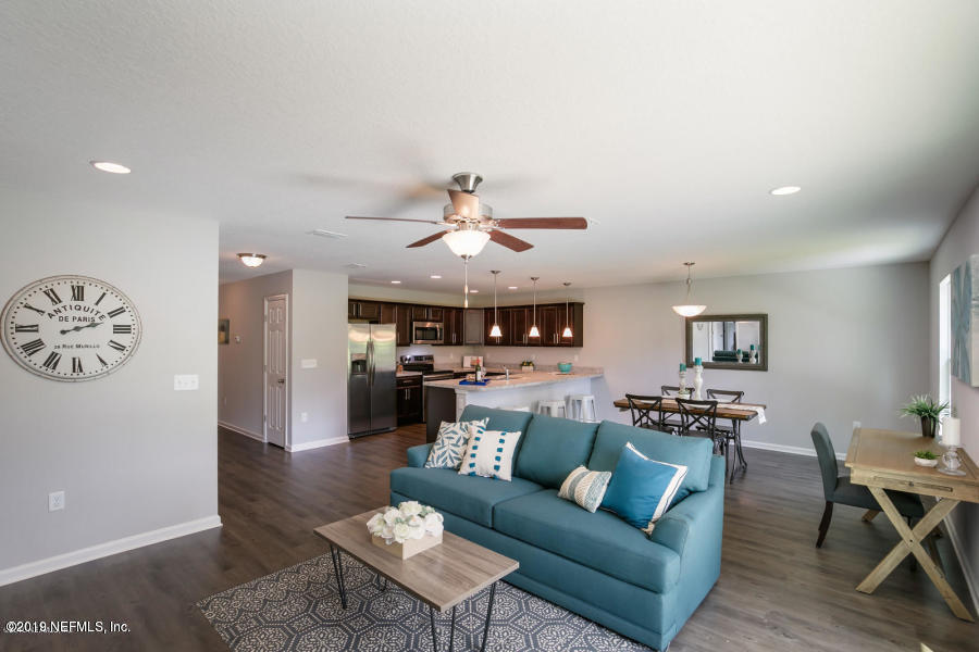 2253 Bayview Road Jacksonville, FL 32210 - Photo 6 of 15 a living room with furniture a rug and a wall painting