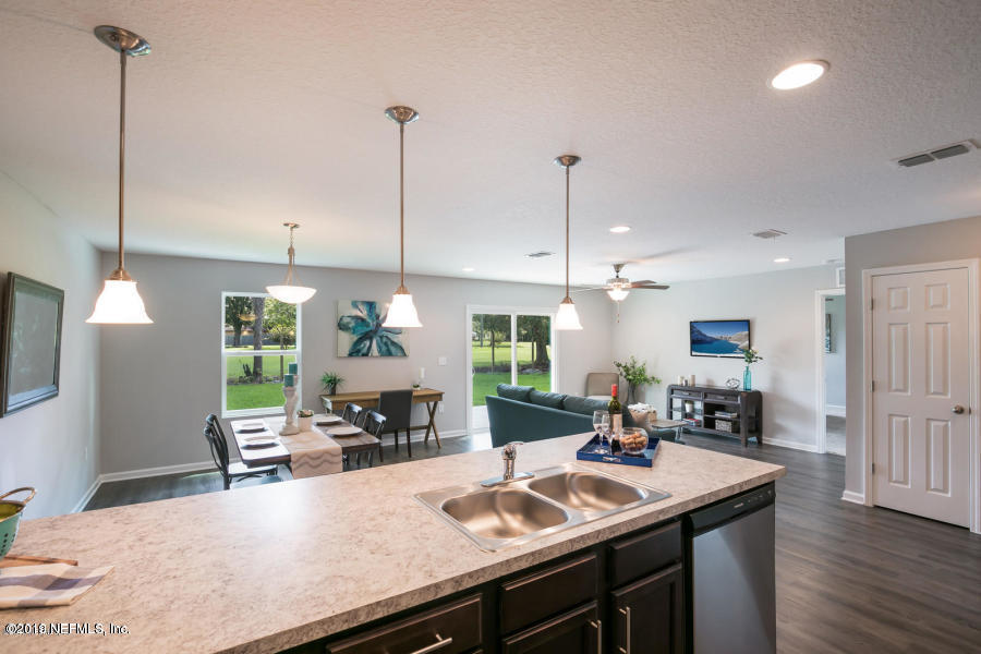 2253 Bayview Road Jacksonville, FL 32210 - Photo 10 of 15 a kitchen with a sink a counter and chairs