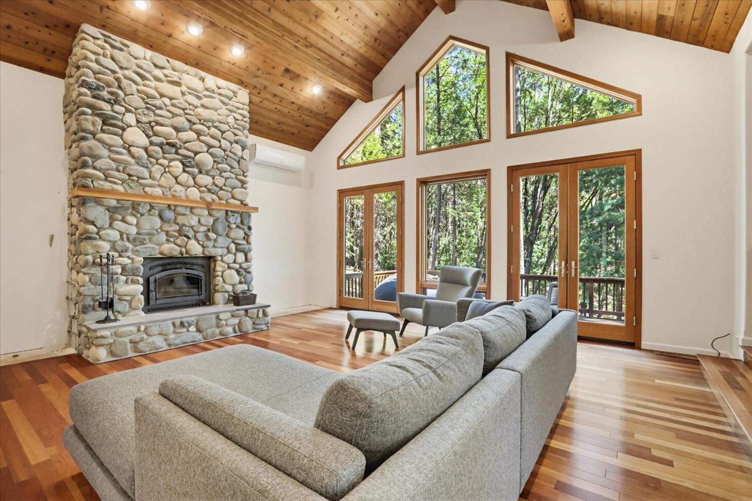 14517 North Bloomfield Road Nevada City, CA 95959 - Photo 6 of 78 a living room with furniture a fireplace and a floor to ceiling window