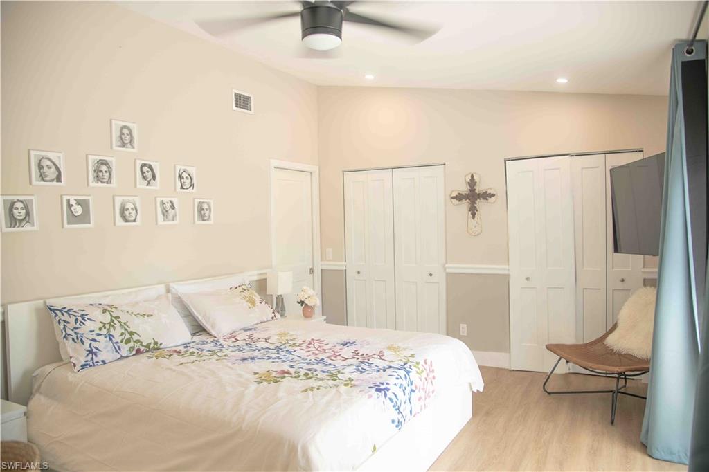 3220 63rd Street Southwest Naples, FL 34105 - Photo 23 of 36 Bedroom with multiple closets, light wood-style flooring, recessed lighting, and a ceiling fan