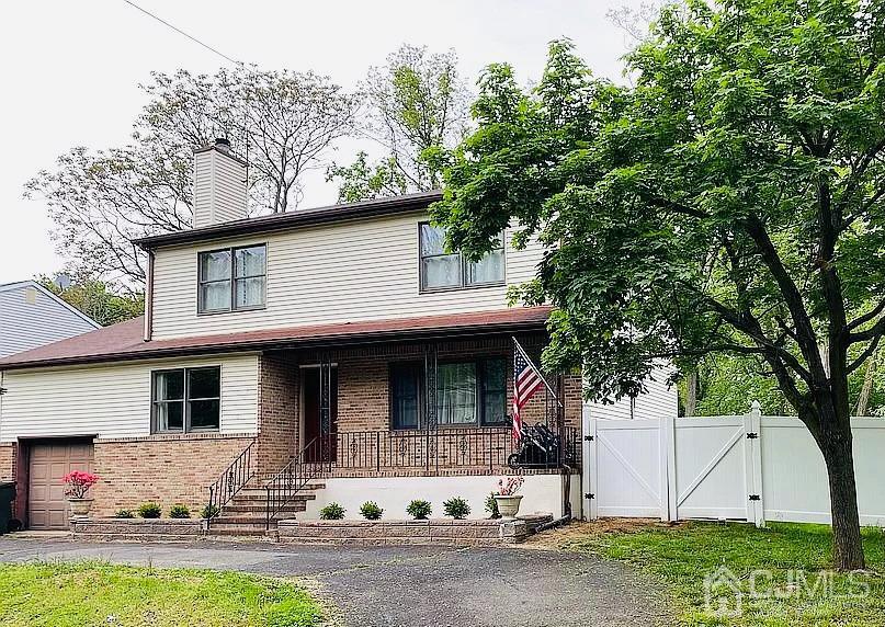 76 Bethany Road Hazlet, NJ 07730 - Photo 1 of 33 a view of a white house with a large tree and a yard