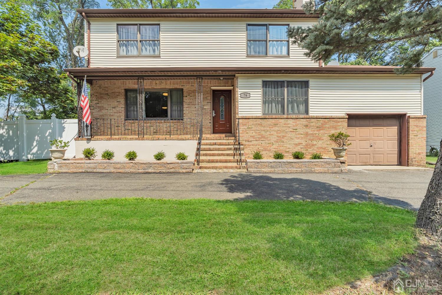 76 Bethany Road Hazlet, NJ 07730 - Photo 2 of 33 a front view of a house with a yard and garage