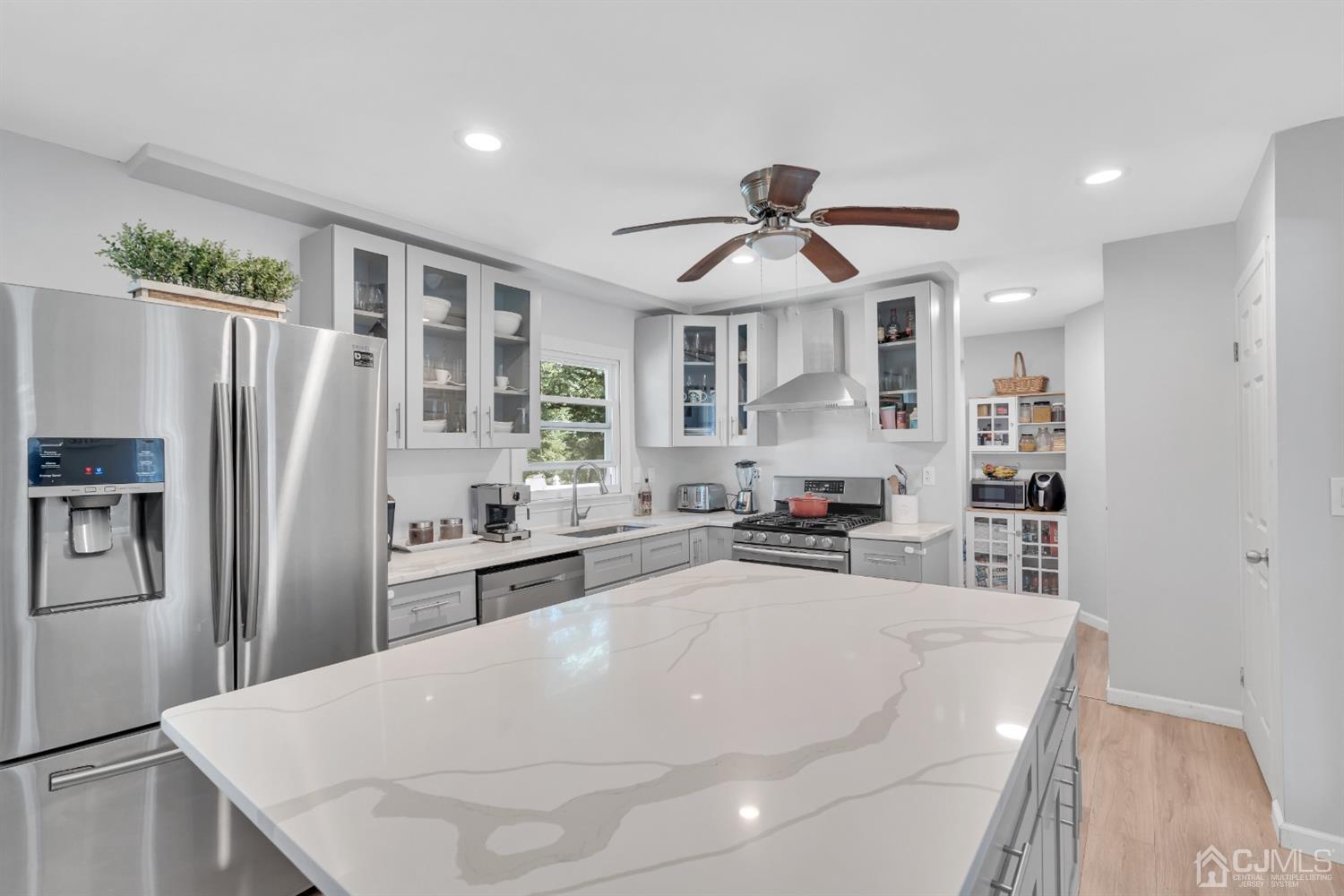 76 Bethany Road Hazlet, NJ 07730 - Photo 14 of 33 a kitchen with stainless steel appliances a refrigerator a sink a stove and cabinets